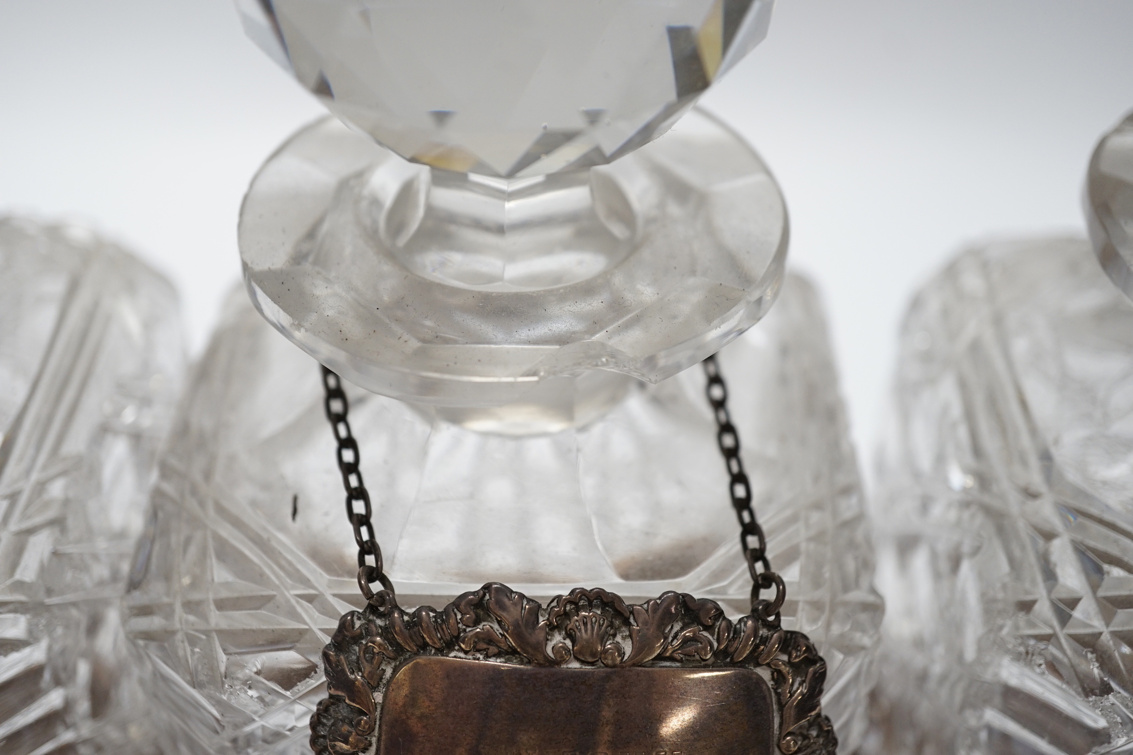 A silver-plated three-bottle oak tantalus, 32cm